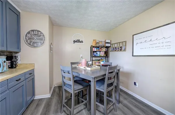 a bedroom with a bed and a flat tv screen on dresser