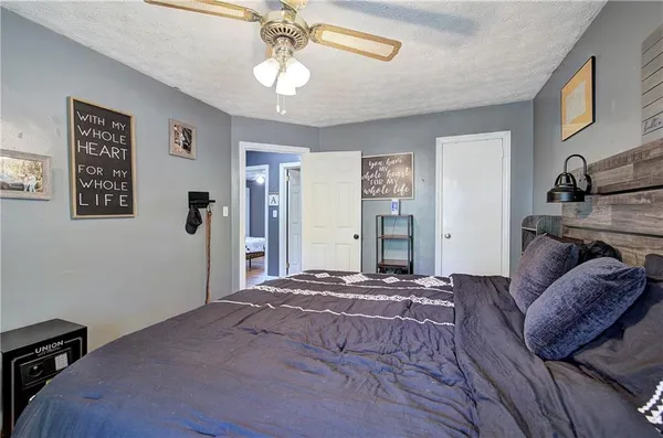 a bathroom with a sink a toilet a window and shower