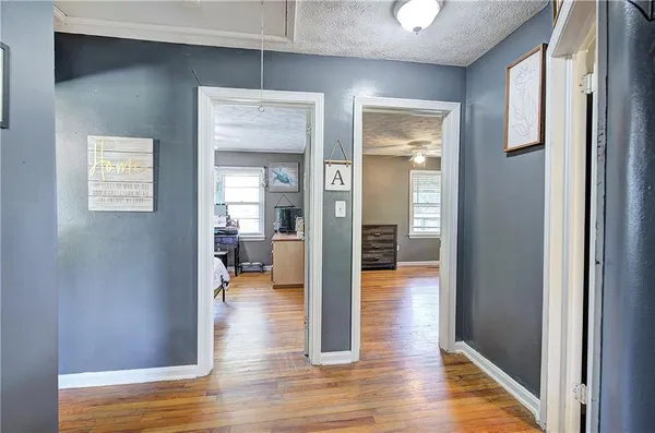 a view of a room with wooden floor and a window