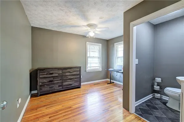 a view of a hallway with wooden floor and closet