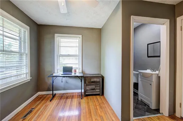 a bathroom with a toilet a sink and mirror