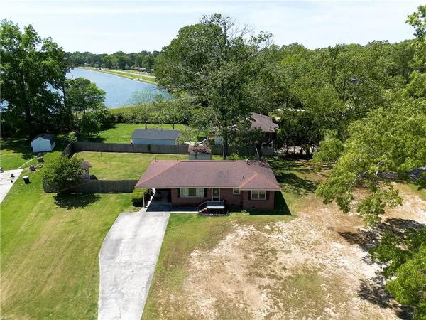 an aerial view of a house with garden space and lake view