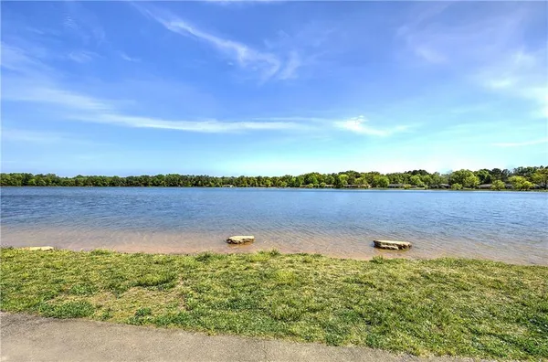 an aerial view of residential house with outdoor space and trees all around