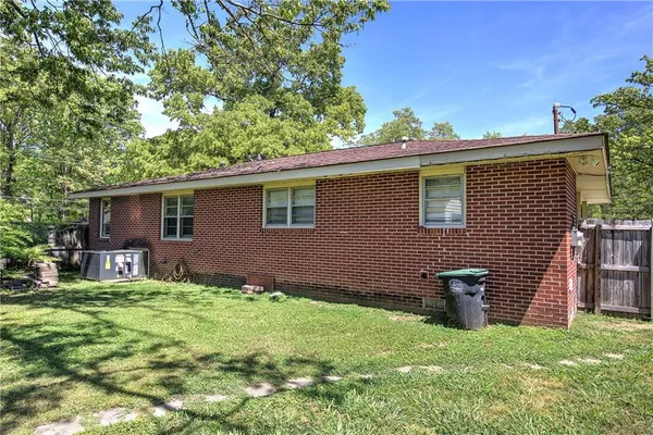 a backyard of a house with table and chairs