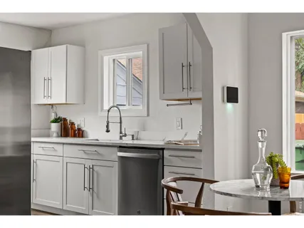 a kitchen with cabinets appliances and a sink