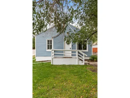 a view of a house with a backyard