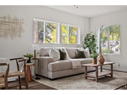a living room with furniture and a large window
