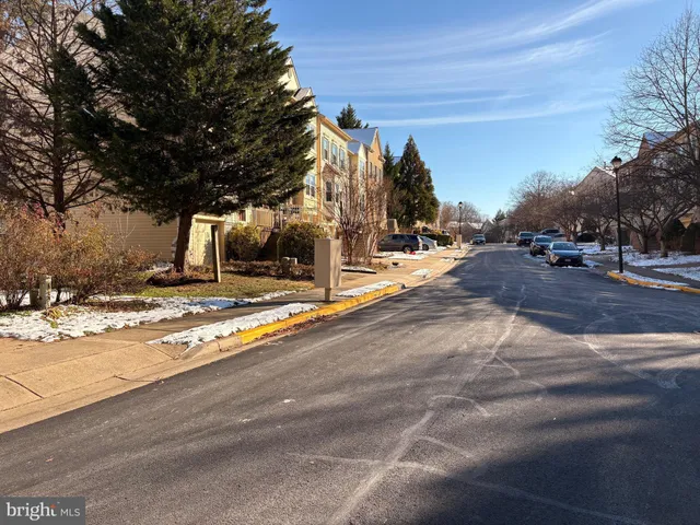 a kitchen with granite countertop white cabinets a refrigerator a sink and dishwasher