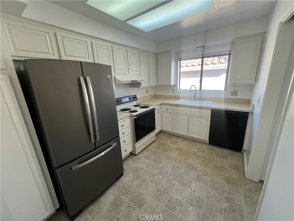 1912 Bataan Road Redondo Beach, CA 90278 - Photo 8 of 37 a kitchen with stainless steel appliances granite countertop a refrigerator a sink a stove and a refrigerator