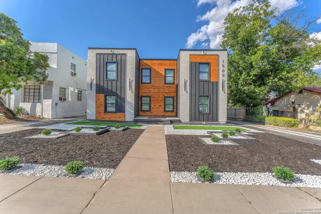 a front view of a house with a yard and a garage