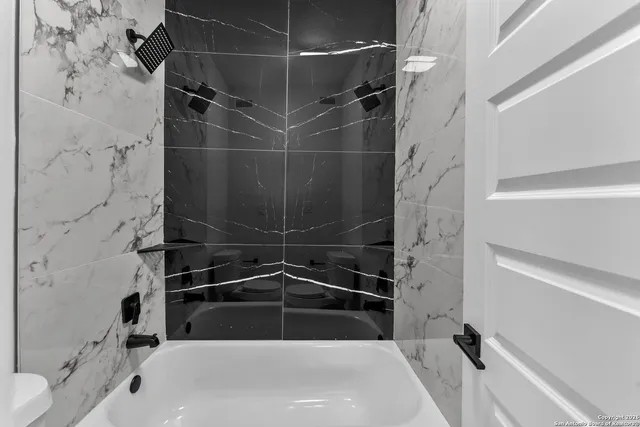 a bathroom with a bathtub and shower