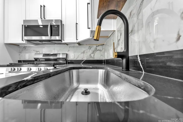 a view of a livingroom with a ceiling fan and window