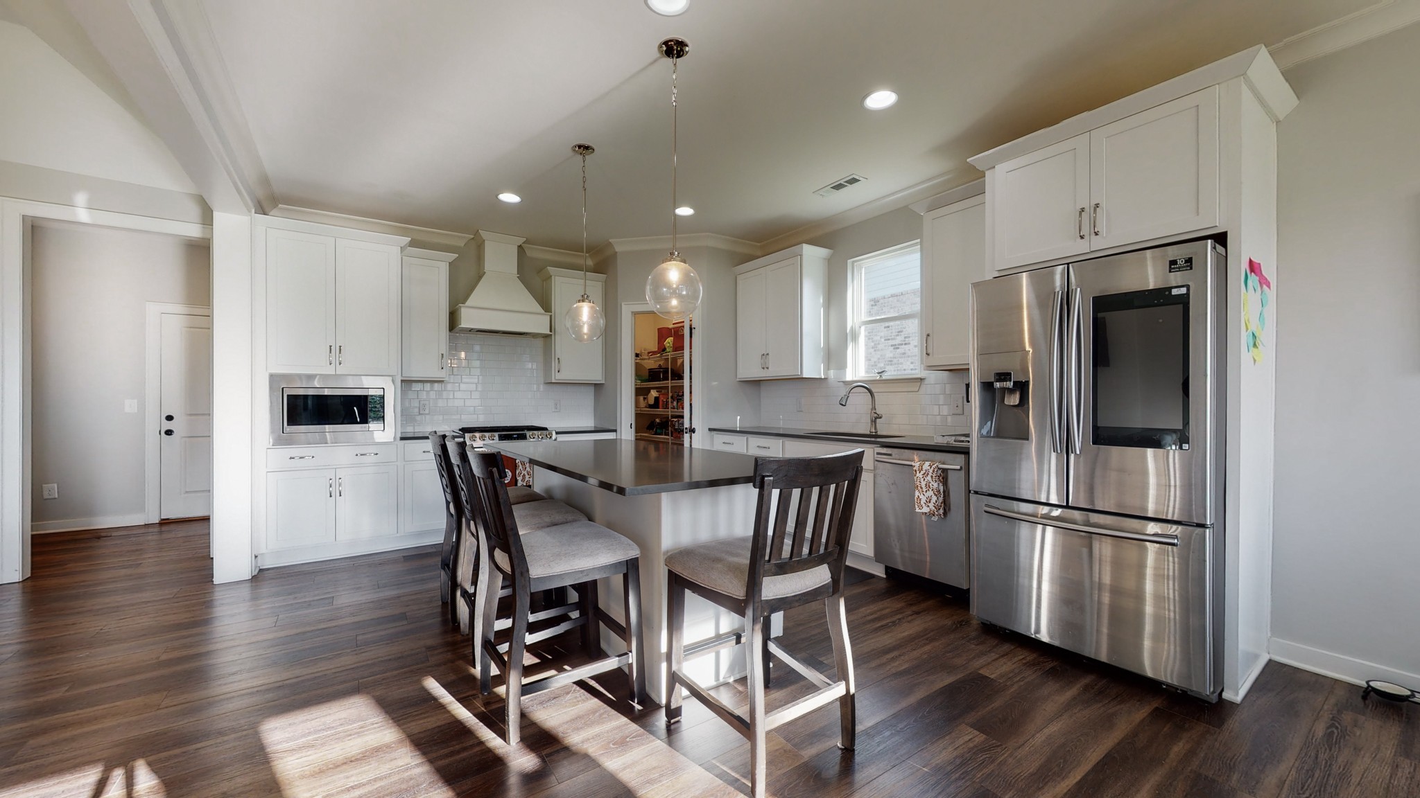 757 Plowson Road Mount Juliet, TN 37122 - Photo 15 of 48 a kitchen with stainless steel appliances a refrigerator a stove a sink dishwasher and a dining table with wooden floor