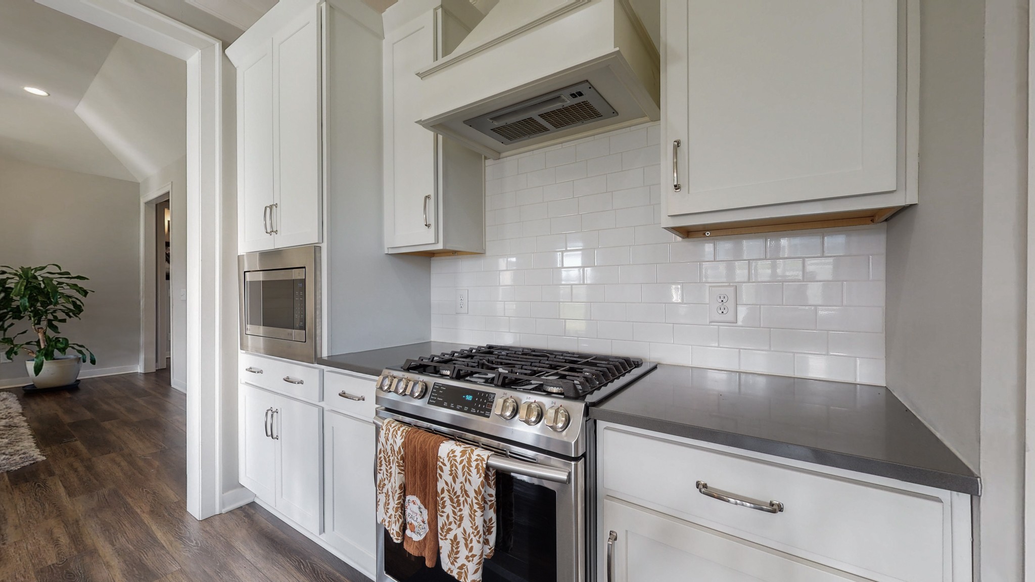 757 Plowson Road Mount Juliet, TN 37122 - Photo 16 of 48 a kitchen with granite countertop a stove and white cabinets