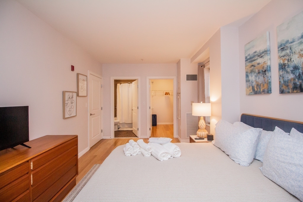 16 Miner Street, Unit 401 Boston, MA 02215 - Photo 12 of 25 a bedroom with a bed and a flat screen tv