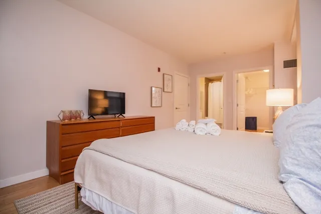 a bedroom with a bed and flat screen tv