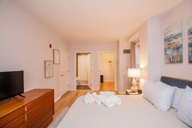 a bedroom with a bed and a flat screen tv