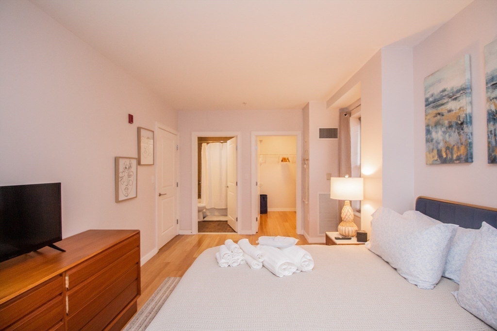 16 Miner Street, Unit 401 Boston, MA 02215 - Photo 14 of 25 a bedroom with a bed and a flat screen tv