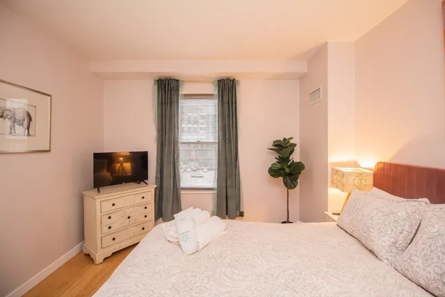 a bedroom with furniture and flat screen tv