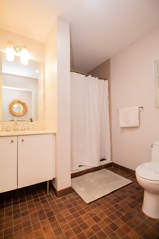 16 Miner Street, Unit 401 Boston, MA 02215 - Photo 22 of 25 a bathroom with a sink and a mirror
