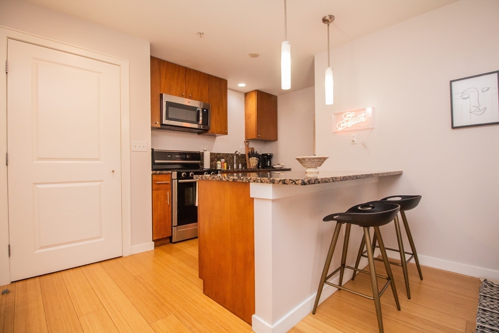 16 Miner Street, Unit 401 Boston, MA 02215 - Photo 7 of 25 a kitchen with stainless steel appliances granite countertop a sink a stove and a refrigerator