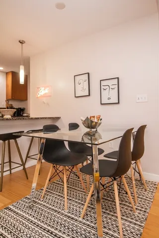 a view of a dining room with furniture and wooden floor