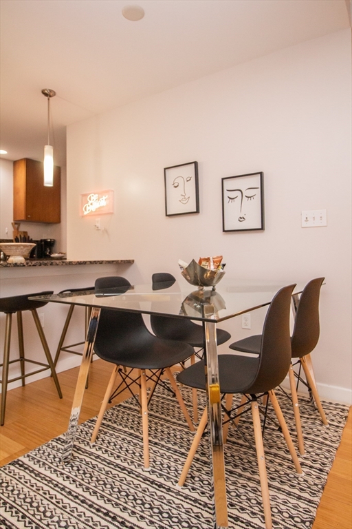 16 Miner Street, Unit 401 Boston, MA 02215 - Photo 8 of 25 a view of a dining room with furniture and wooden floor