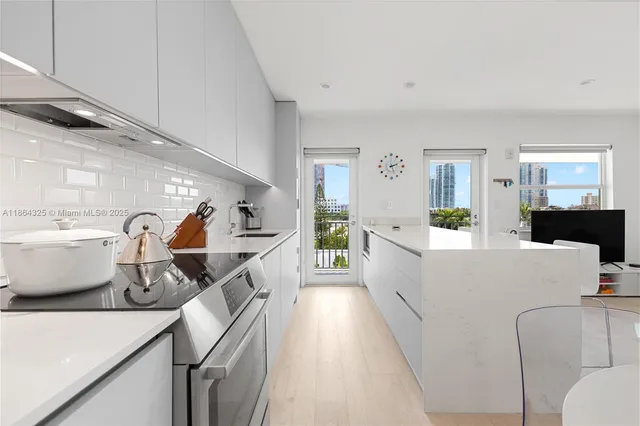 a living room with furniture a wooden floor and a large window