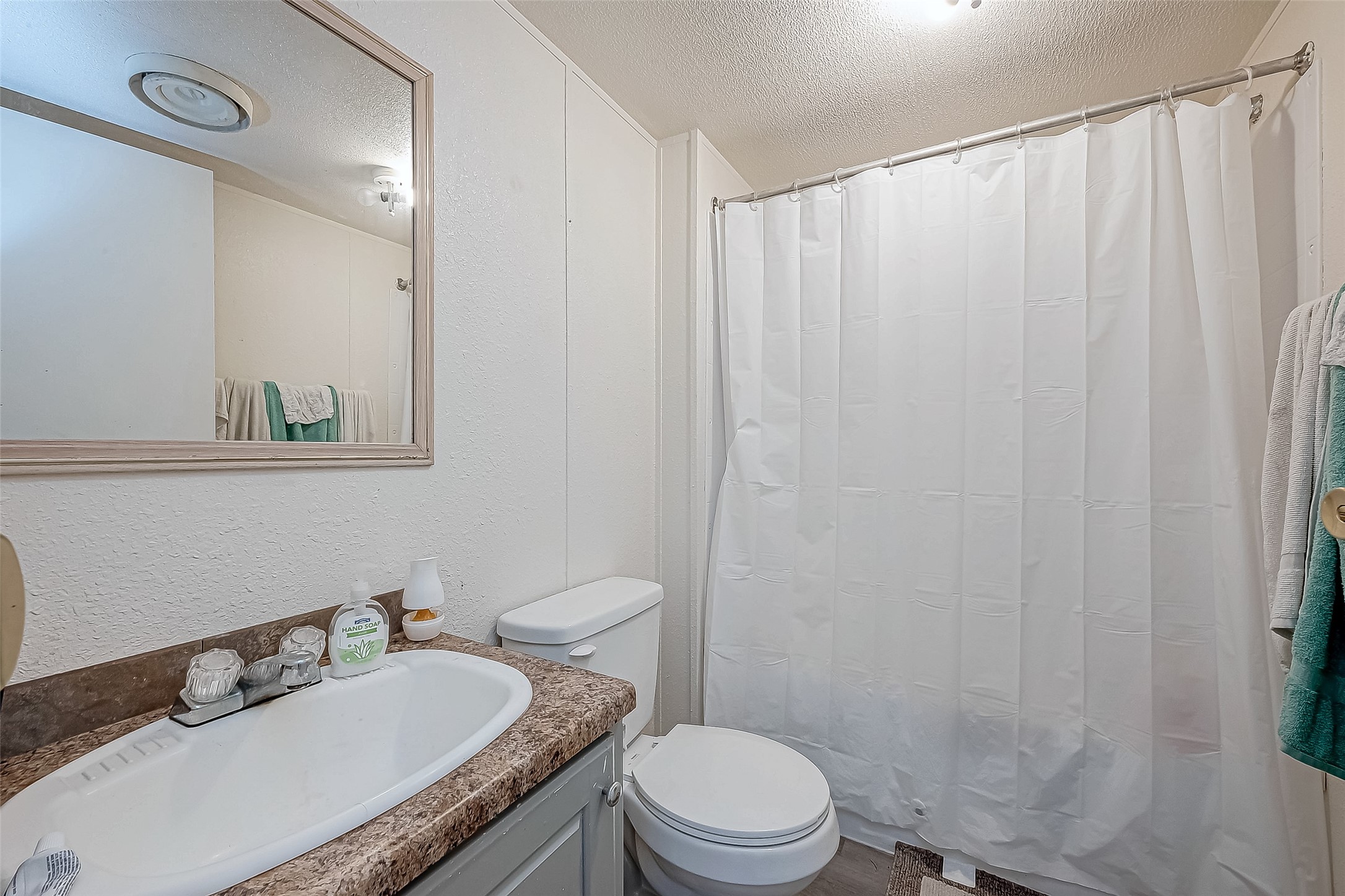 100 Mulcahy Avenue, Unit 264 Damon, TX 77430 - Photo 11 of 30 a bathroom with a granite countertop sink toilet and a mirror