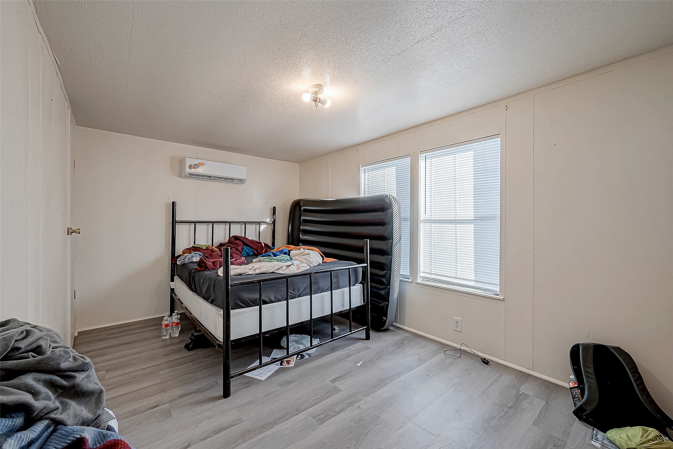 100 Mulcahy Avenue, Unit 264 Damon, TX 77430 - Photo 12 of 30 a bedroom with a bed and wooden floor