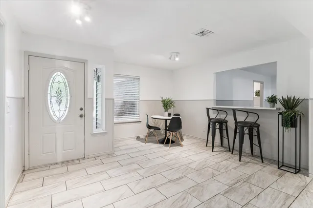 a living room with furniture a clock and a window