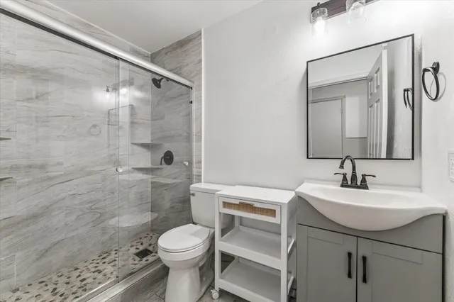 a bathroom with a sink toilet and shower