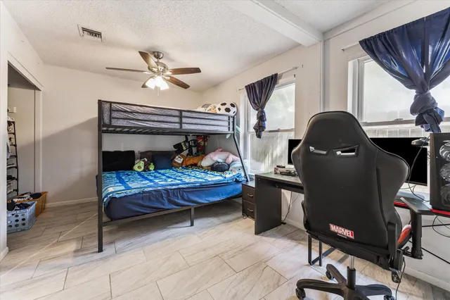 a bedroom with furniture and a window