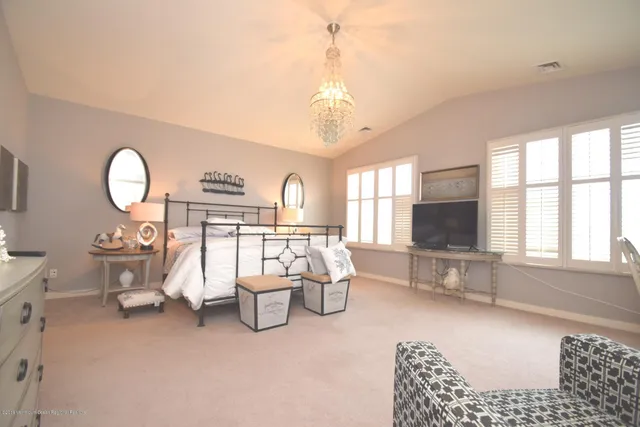 a living room with furniture a flat screen tv and large window