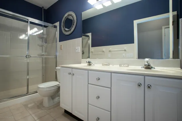 a bathroom with a toilet a sink and a mirror