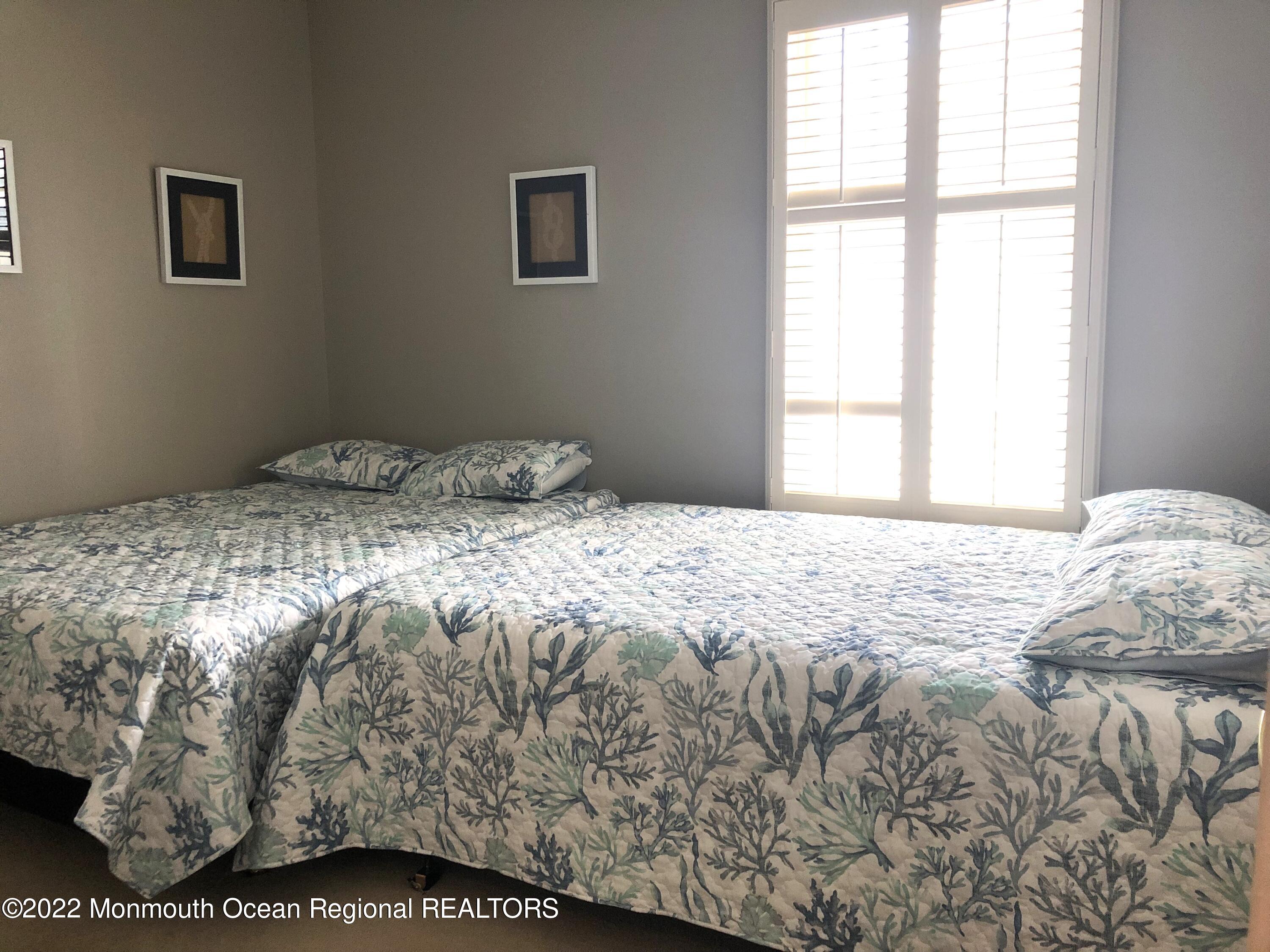 239 Beach Front, Unit 4 Manasquan, NJ 08736 - Photo 10 of 14 a bedroom with a bed and a window