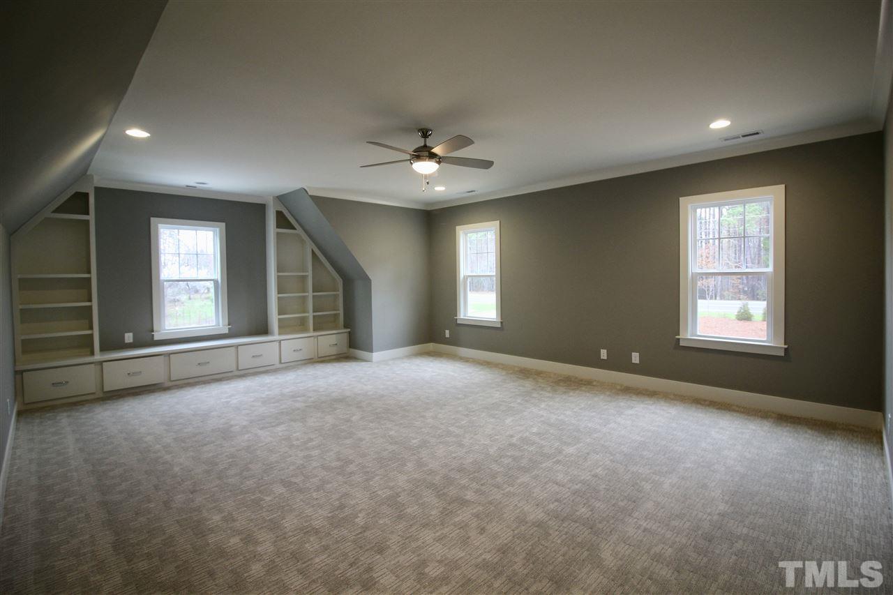 8908 Ashton Garden Way Raleigh, NC 27613 - Photo 14 of 23 an empty room with windows and ceiling fan