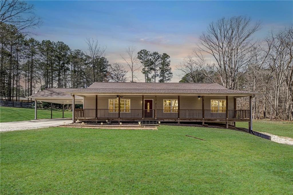 a big house with a big yard and dinning table and chairs in a yard