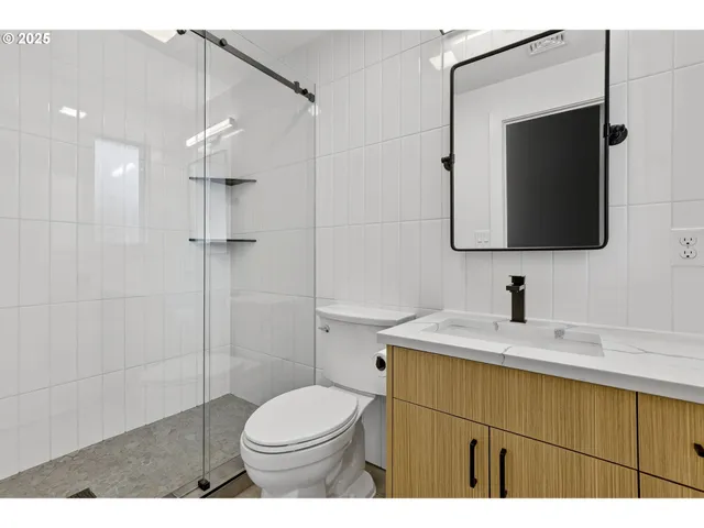 a bathroom with a sink a toilet and mirror