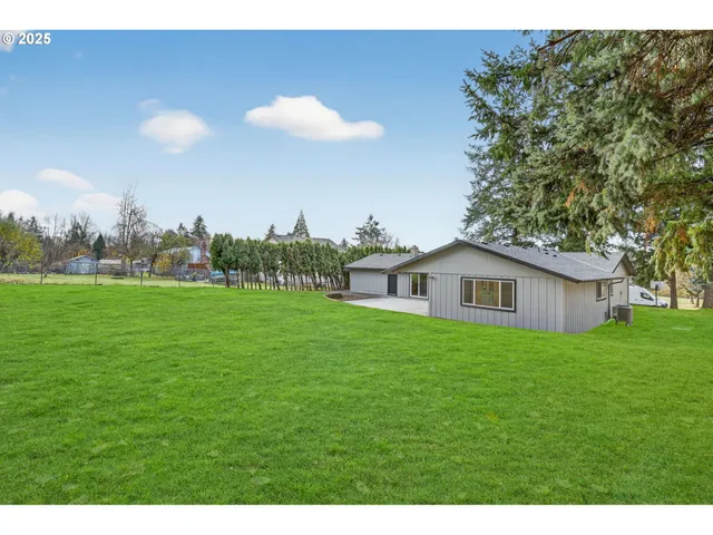 a view of a house with a backyard