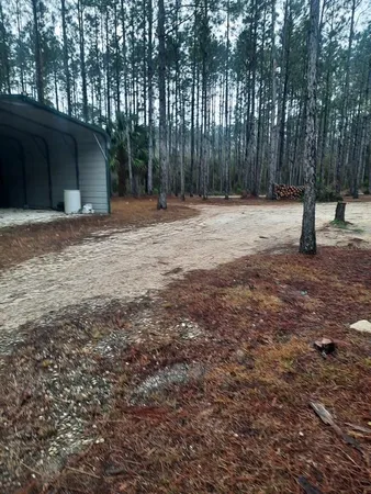 a backyard of a house with lots of green space