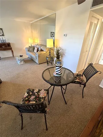 a room with table chairs and a chandelier