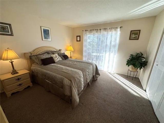a spacious bedroom with a bed and a large window