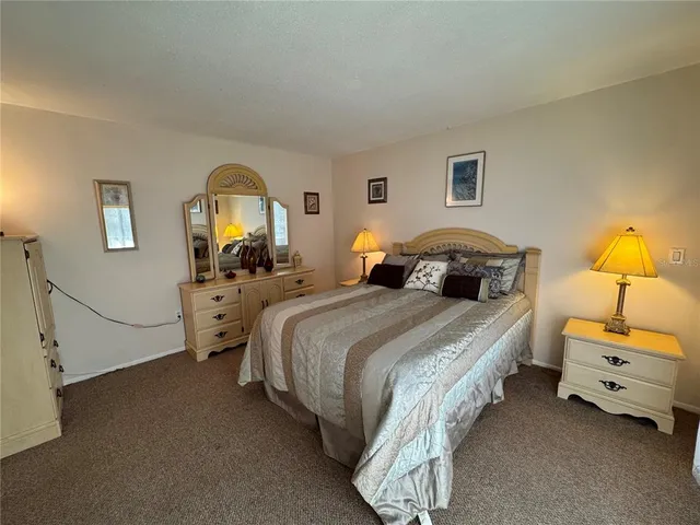 a bed room with a bed and a mirror