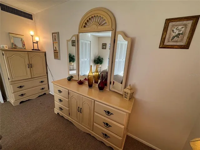 a bathroom with a sink and mirror with toilet