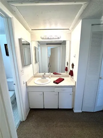 a bathroom with a double vanity sink and mirror