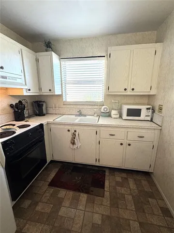 a kitchen with a refrigerator stove and sink