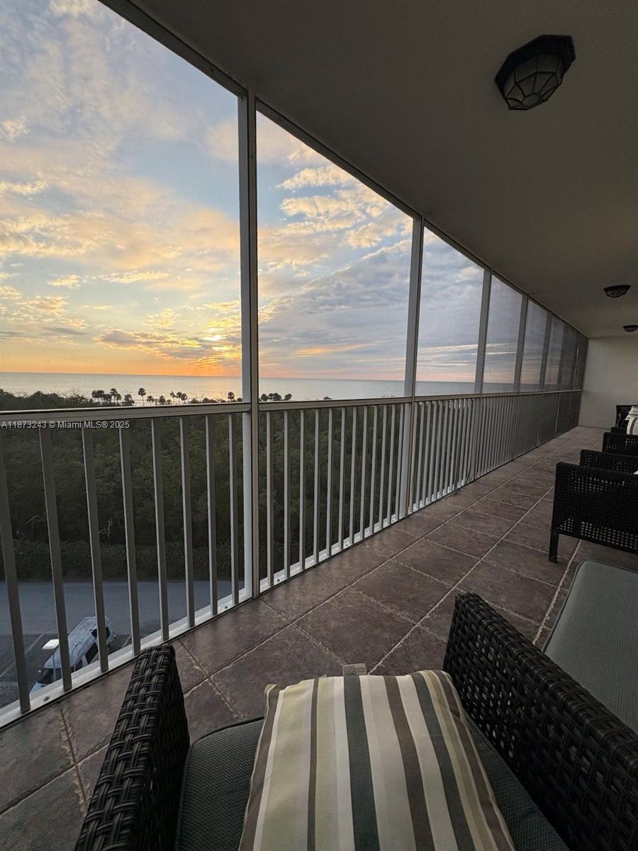 5 Bluebill Avenue, Unit 701 Naples, FL 34108 - Photo 21 of 21 a view of balcony with floor to ceiling windows with wooden floor