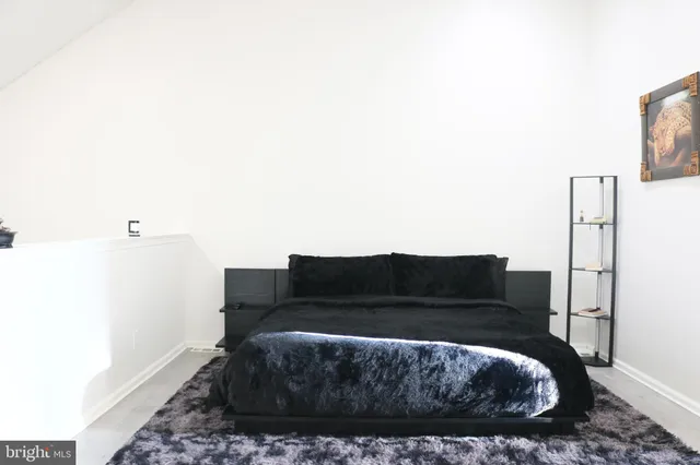 a living room with a couch and a potted plant