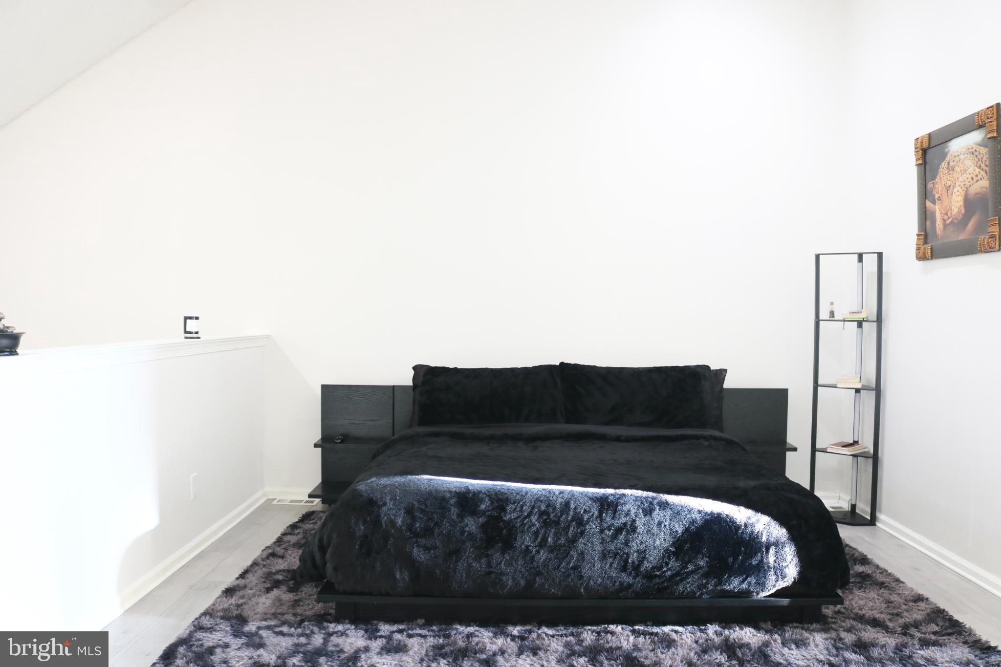 1031 Main Street Voorhees, NJ 08043 - Photo 14 of 32 a living room with a couch and a potted plant